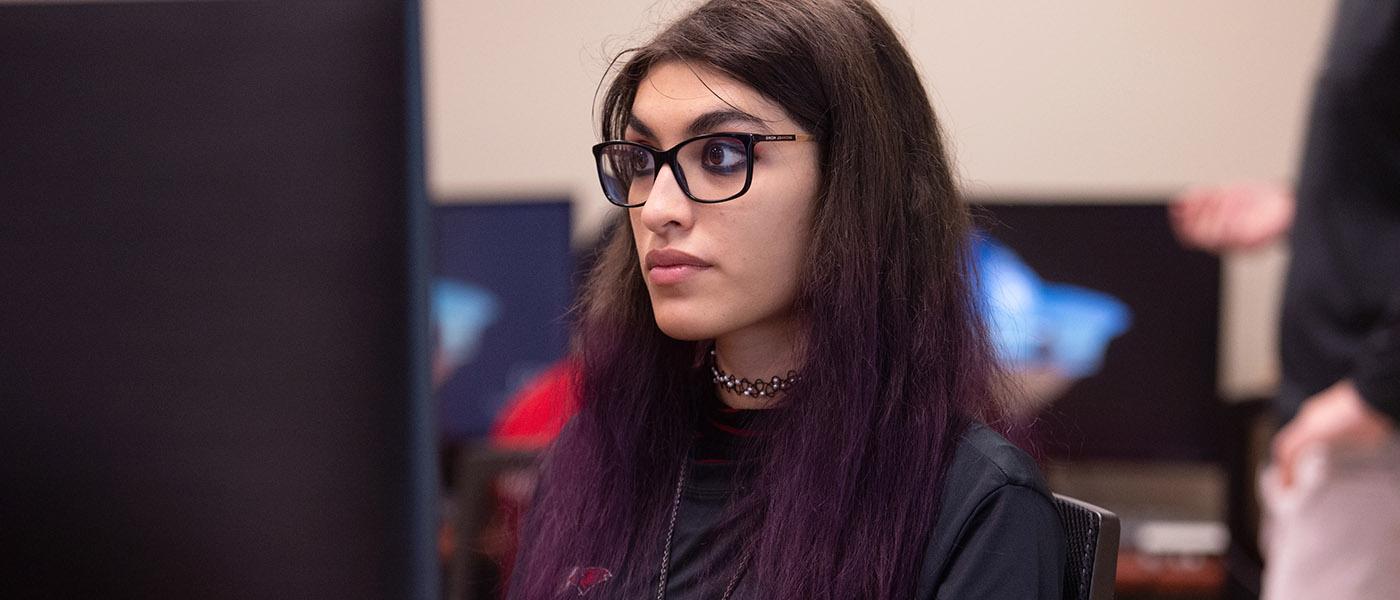 Close up of CIS student at her computer workstation during class